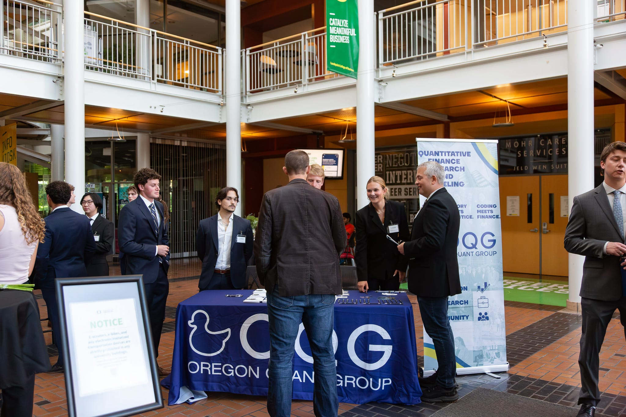 A member at the OQG table talking with an industry professional