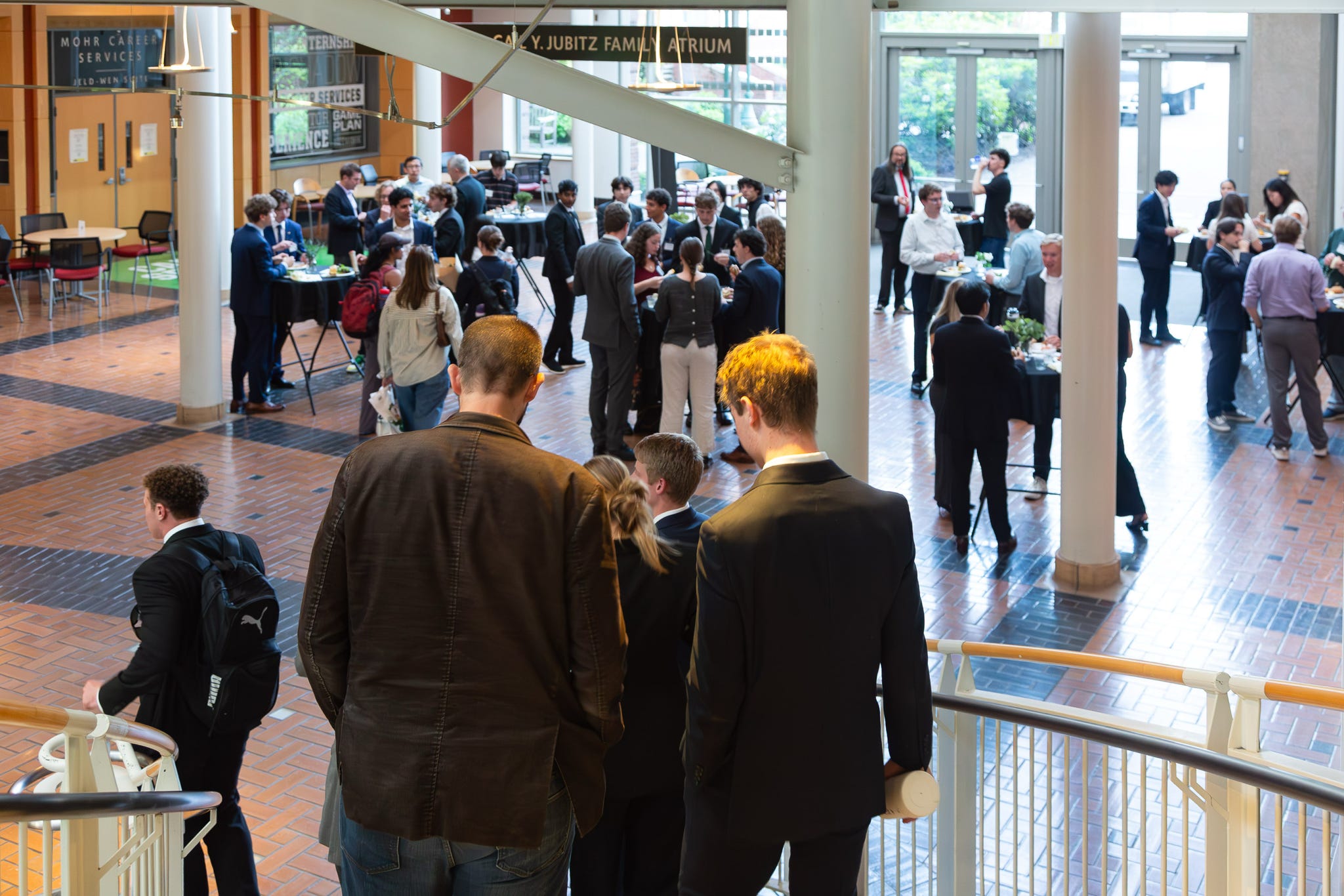 A full atrium reception seen from the stairs above