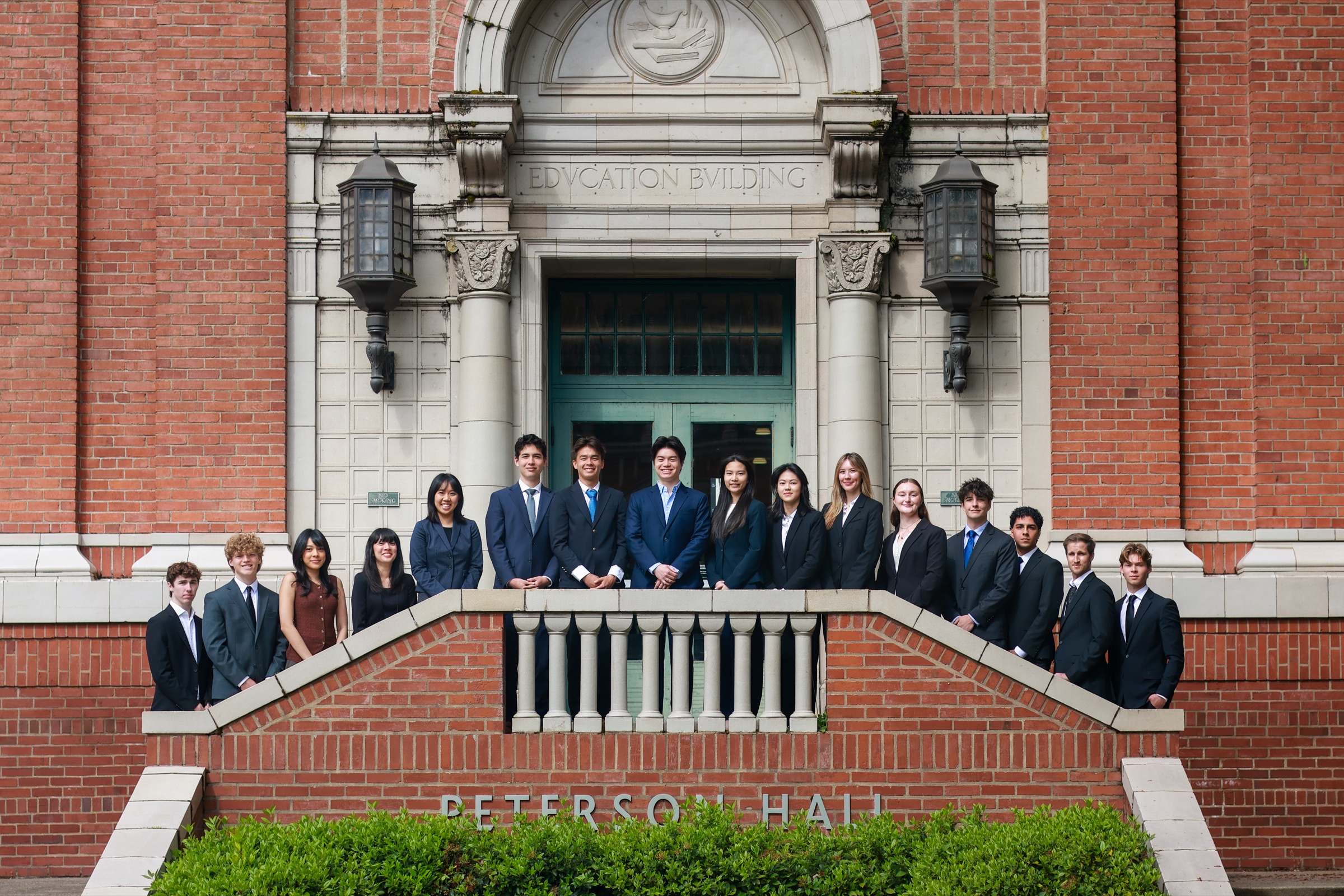 The Oregon Quant Group team in suits on the steps of the Education Building